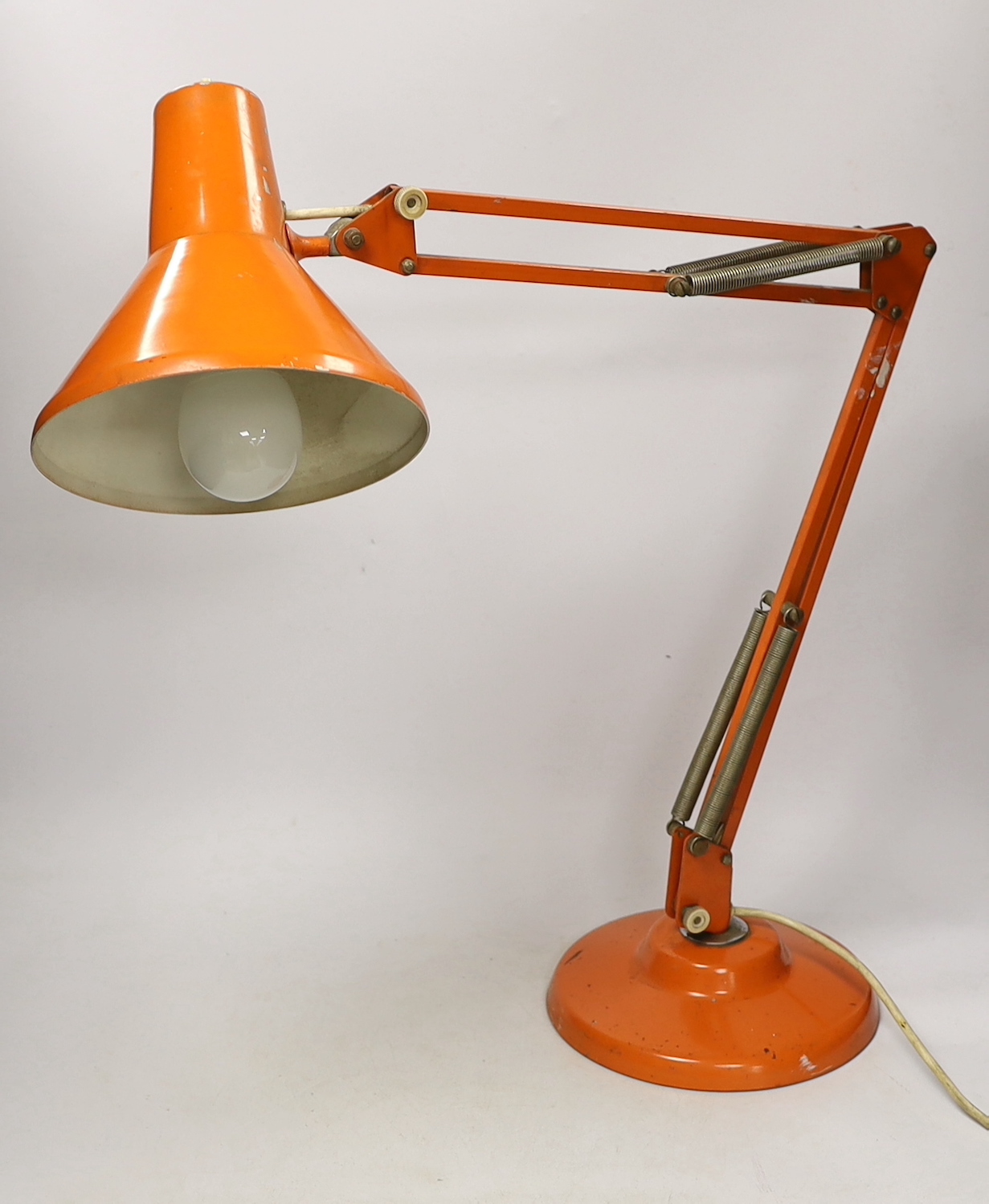 An orange Thousand and One Lamps Ltd angle poise lamp, approximately 76cm high